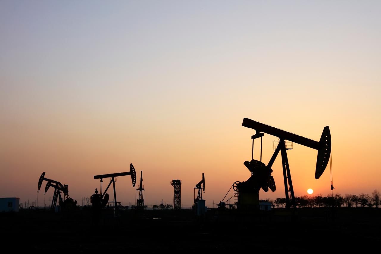 In the field, the oil pump in the evening, the evening silhouette of the pumping unit, the silhouette of the oil pump