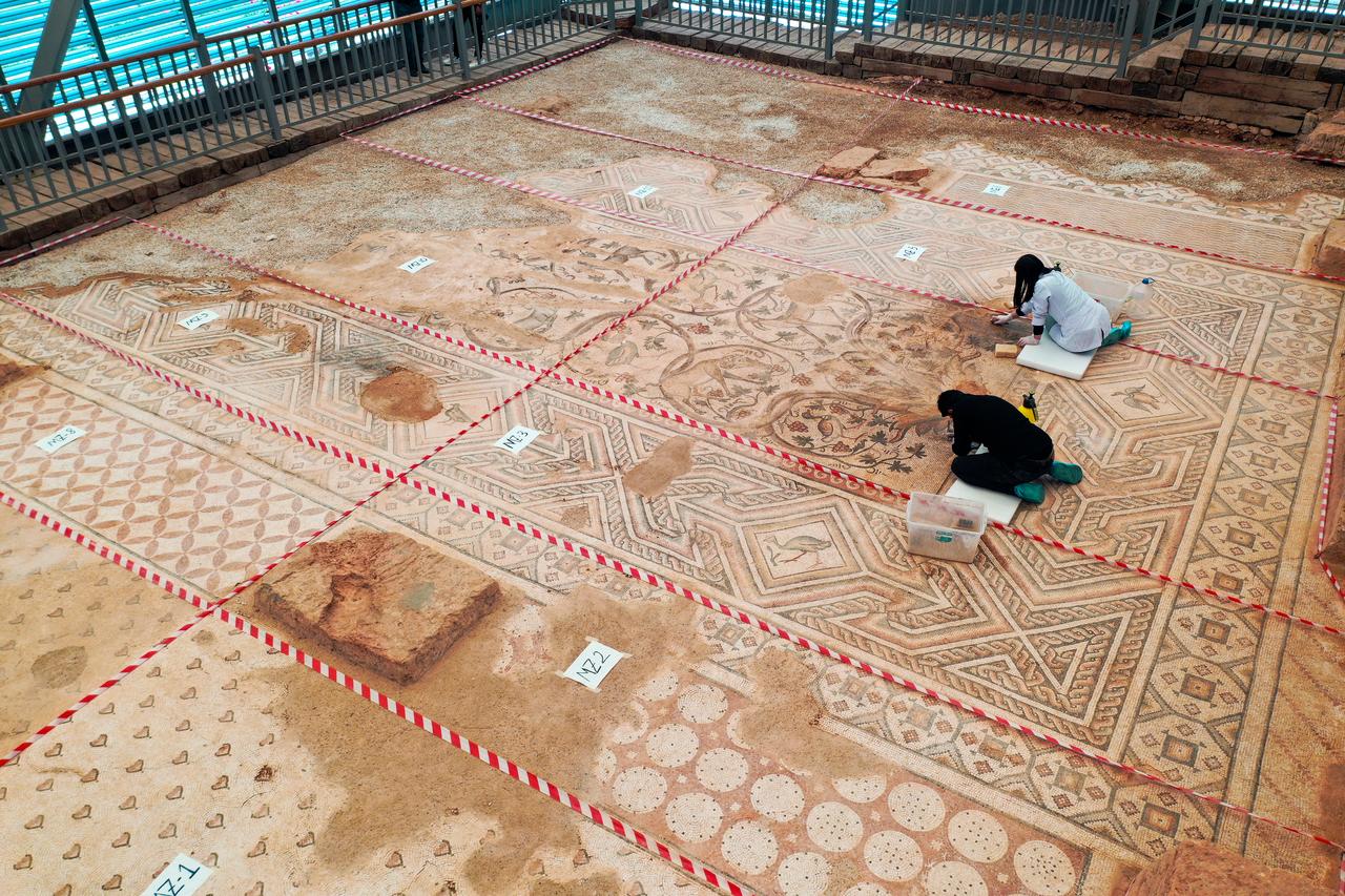 Conservation experts work on a 1,500-year-old floor mosaic, an archaeological treasure known for its intricate geometric patterns and impressive scale, found in the ancient city of Perre in Adiyaman, Türkiye, May 30, 2025. (AA Photo)