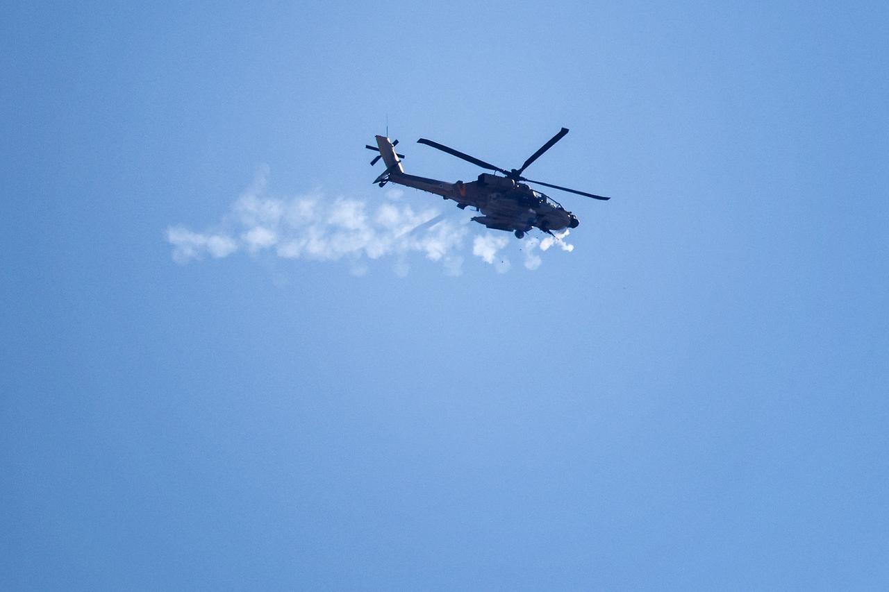 An Israeli AH-64 Apache Longbow helicopter fires its machine gun near Israels northern border with the Gaza Strip on May 29, 2025. The White House said on May 29 that Israel had  signed off on  a new Gaza ceasefire proposal submitted to the Palestinian Hamas movement, which confirmed it was studying the deal. (Photo by Jack GUEZ / AFP)