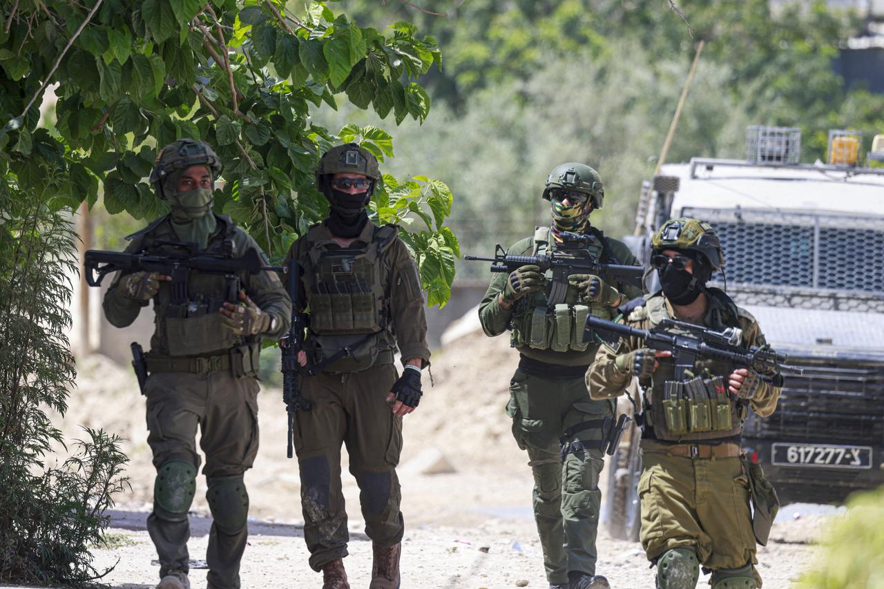 Israeli soldiers patrol in the Tulkarem camp for Palestinian refugees after an evacuation order was issued to the residents whose houses were scheduled to be demolished on May 26, 2025, amid an ongoing Israeli offensive in the occupied West Bank. (Photo by Jaafar ASHTIYEH / AFP)