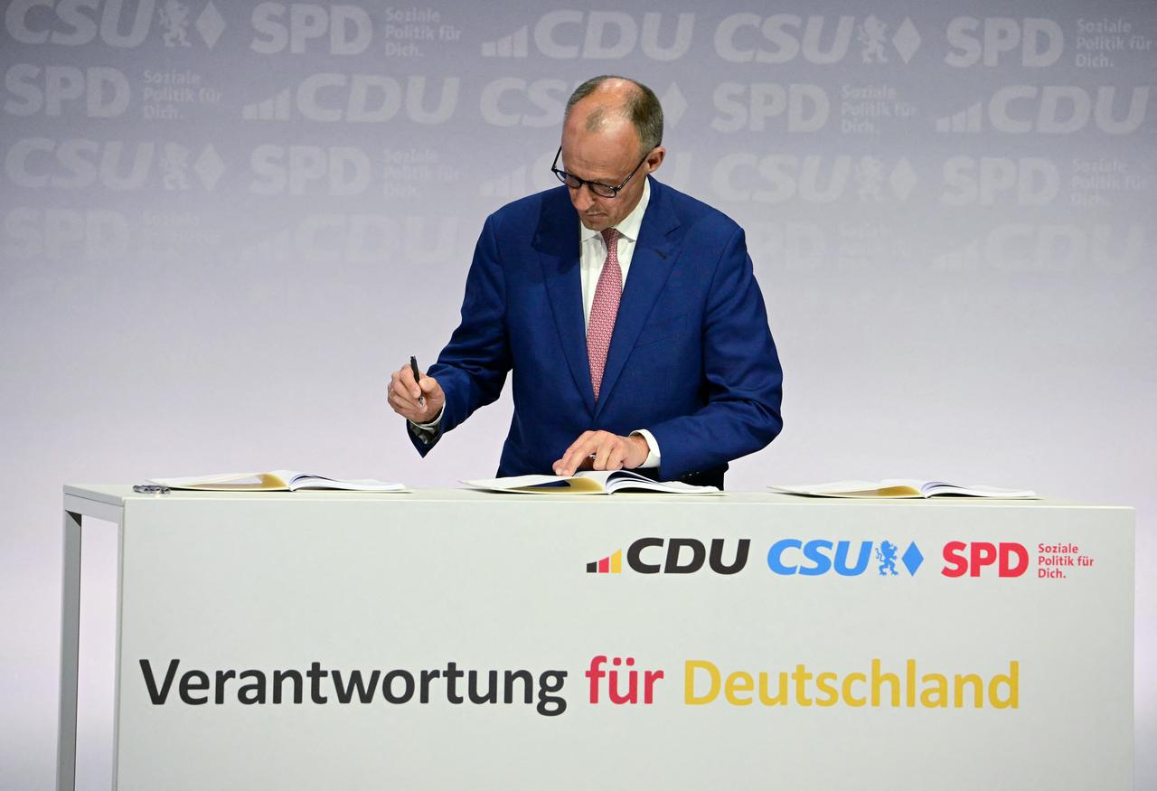 The leader of Germany's conservative Christian Democratic Union (CDU) party Friedrich Merz signs a coalition deal to form the country's new government along with the conservative Bavarian Christian Social Union (CSU) party and the Social Democratic Party (SPD)  in Berlin, on May 5, 2025. (AFP Photo)