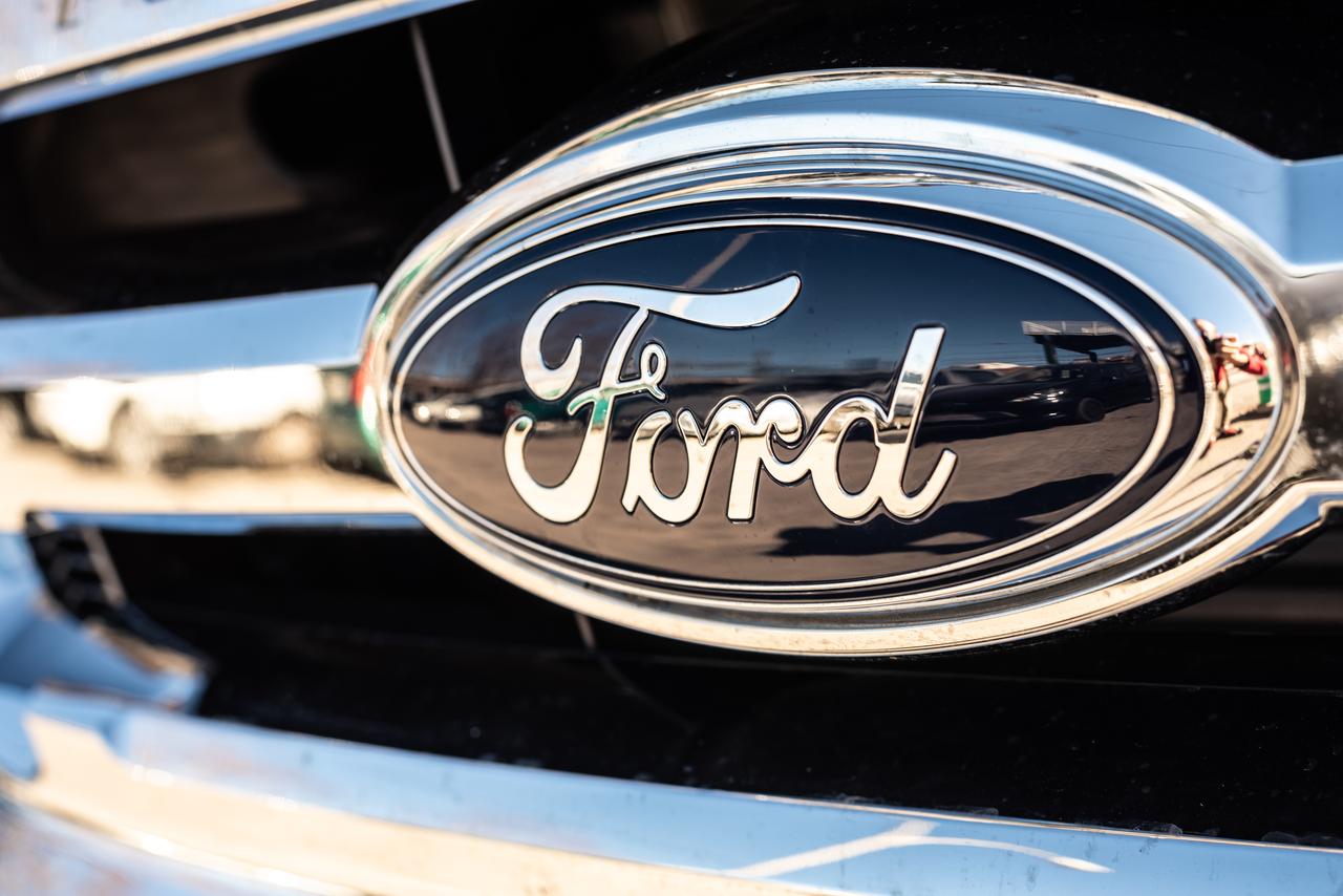 The photo shows a close-up of the Ford logo on the grille of a parked vehicle in Valencia, Spain, on January 13, 2019. (Adobe Stock Photo)