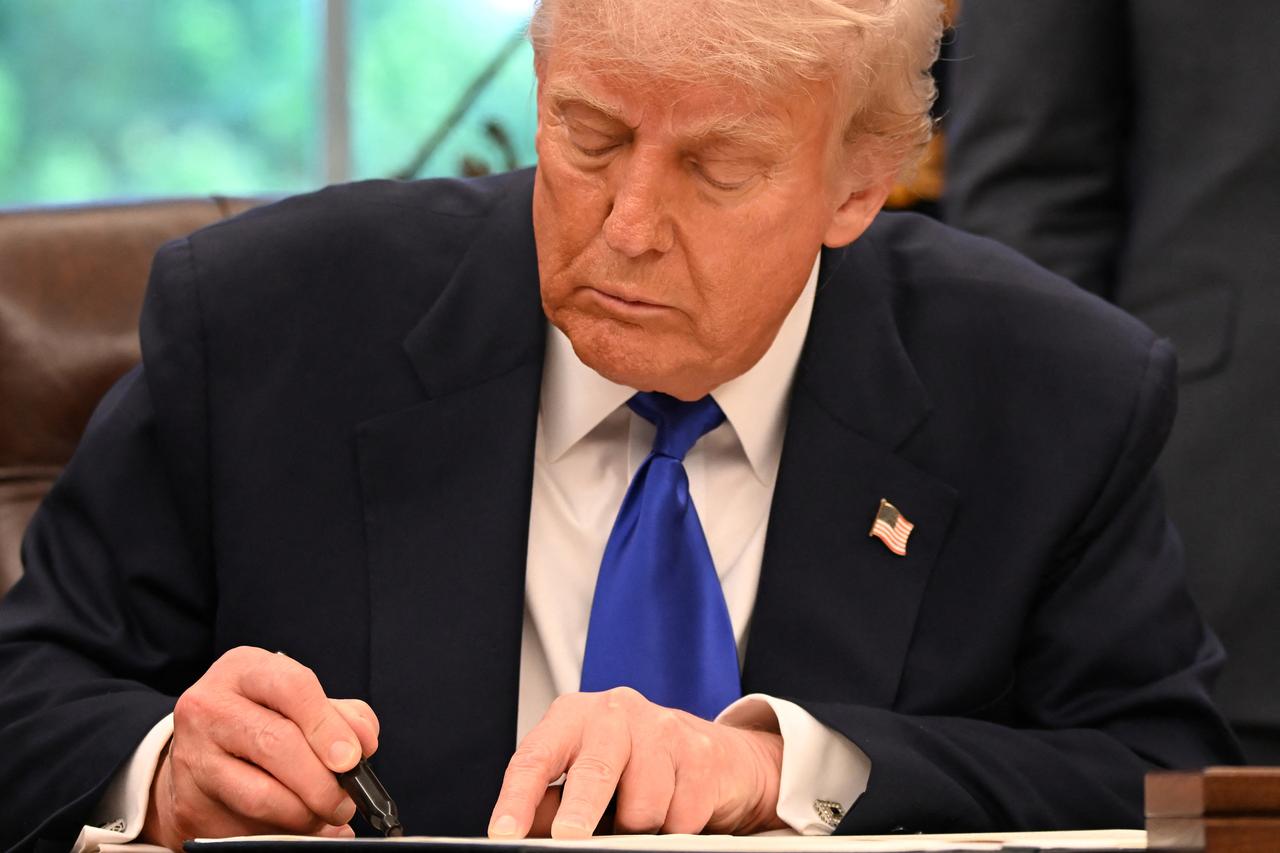 US President Donald Trump signs executive orders in the Oval Office of the White House, in Washington, DC, on May 5, 2025. (AFP Photo)