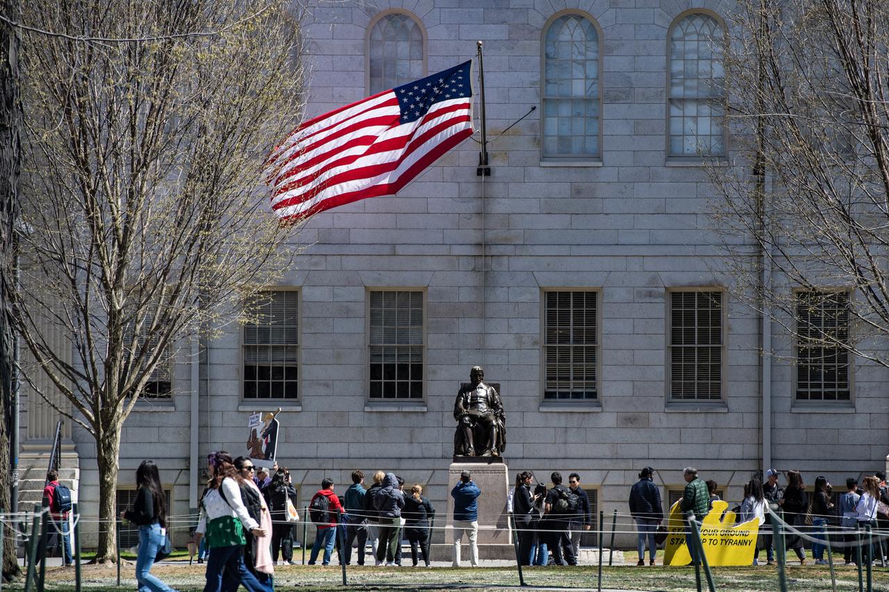 Demonstrators with signs stand around the John Harvard Statue in Harvard Yard following a rally against President Donald Trump’s attacks on Harvard University at Harvard University in Cambridge, Massachusetts on April 17, 2025. (AFP Photo)