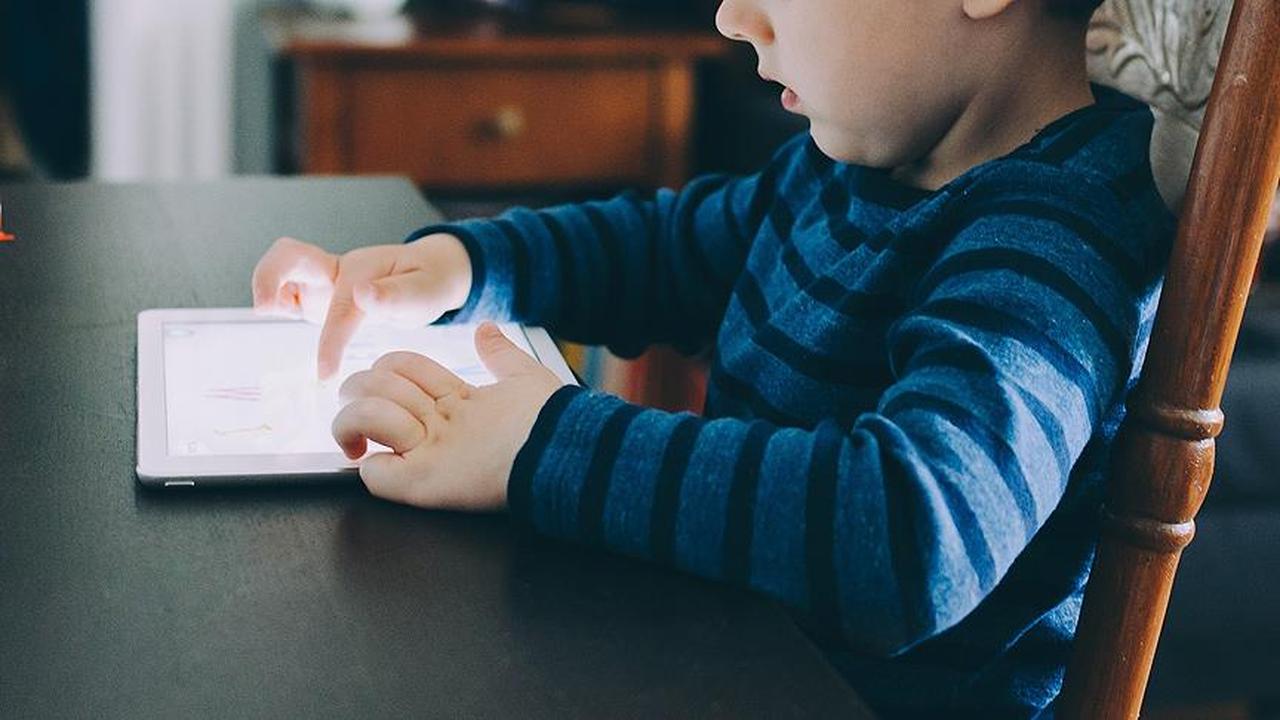 File photo shows a child using a tablet at home, accessed on May 7, 2025. (AA Photo)