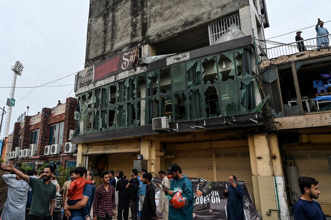 People gather in front of the shattered glasses of a restaurant outside the Rawalpindi cricket stadium after an alleged drone was shot down in Rawalpindi, Pakistan on May 8, 2025. (AFP Photo)