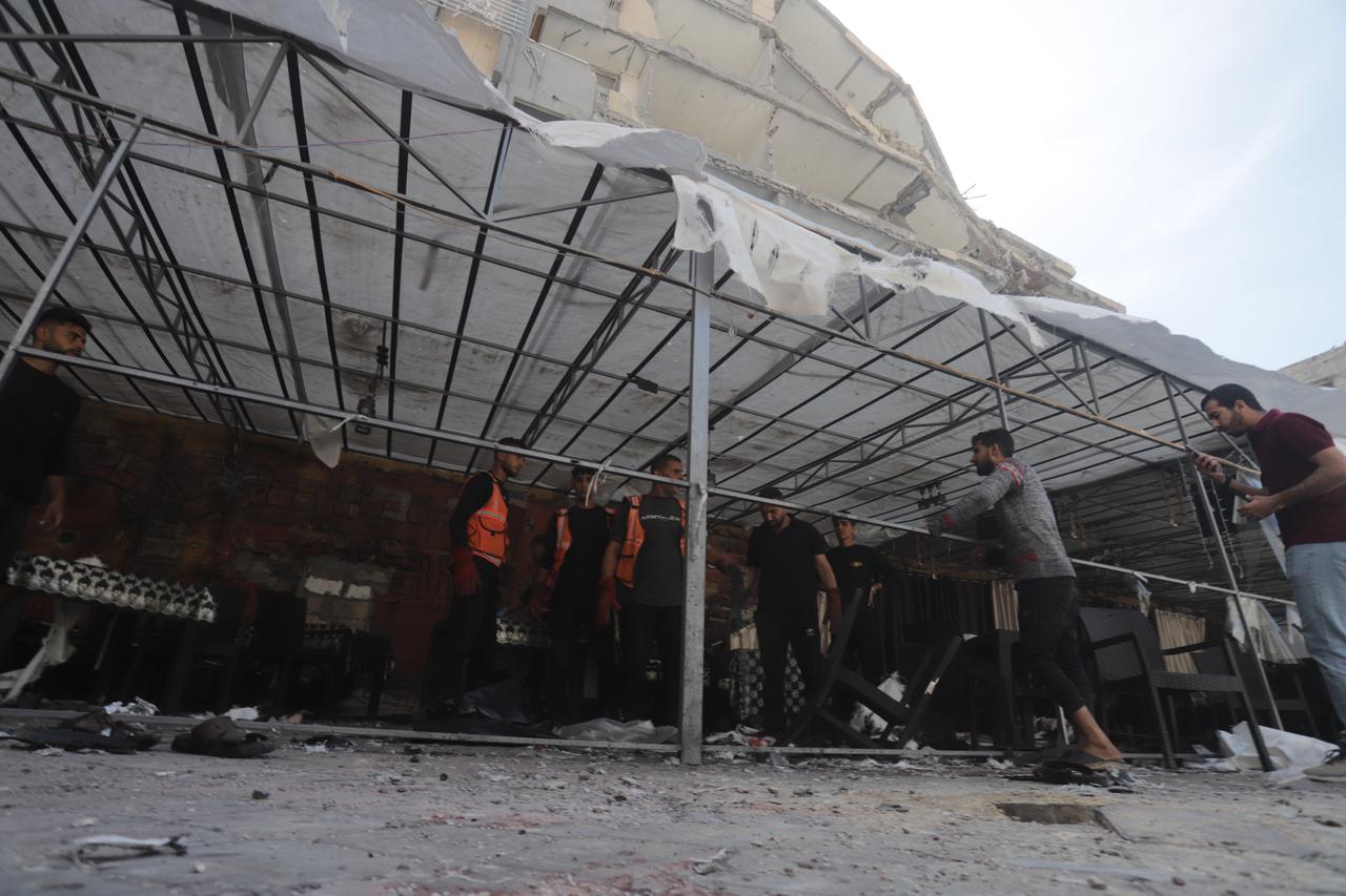 Emergency crews and residents inspect a destroyed displacement shelter after an Israeli airstrike in Gaza City, May 7, 2025. (AA Photo)