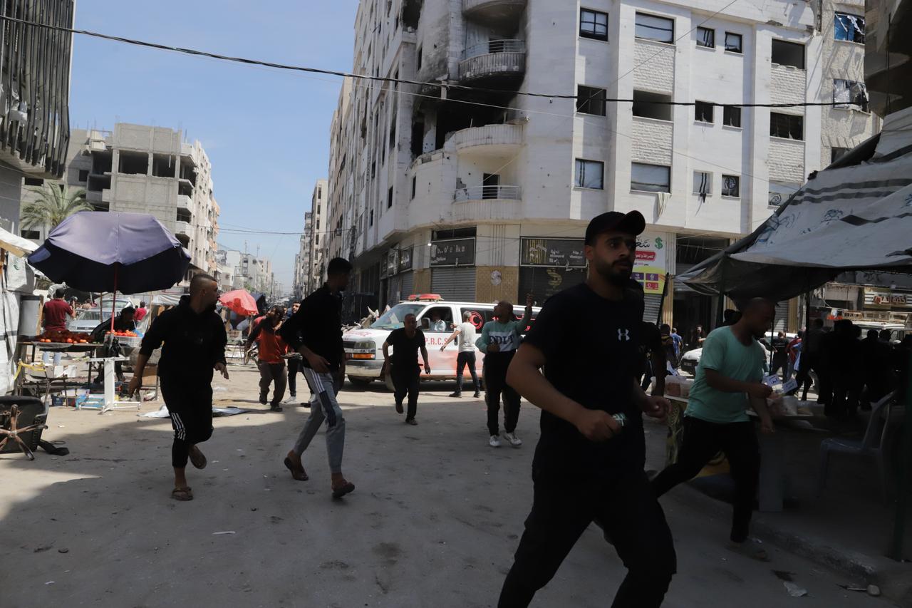 People run for cover as an Israeli airstrike hits a residential area in central Gaza, May 7, 2025. (AA Photo)