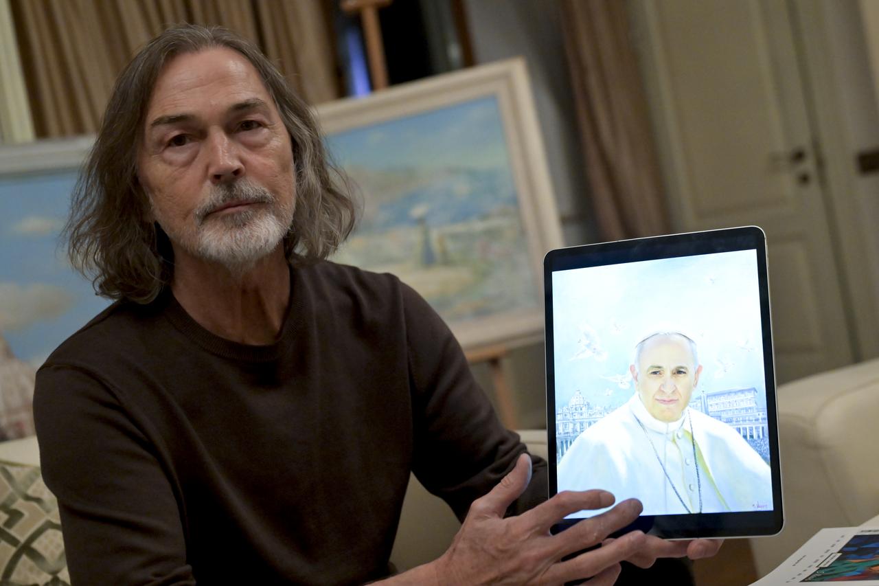 Russian artist Nikas Safronov is seen holding a portrait of Pope Francis during an exclusive interview in Moscow, Russia, May 6 2025. (AA Photo)