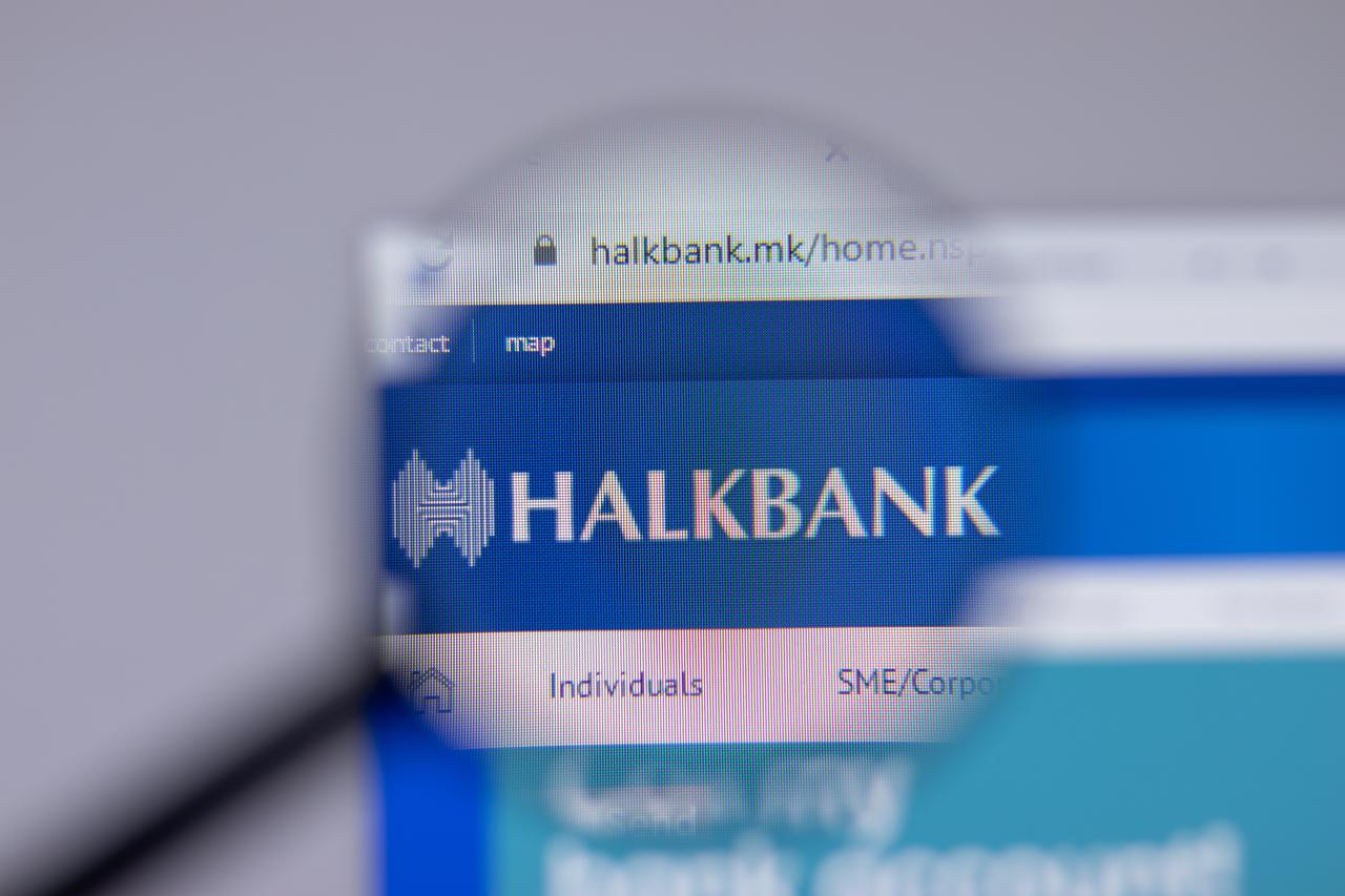 Photo illustration shows Halkbank’s website displayed under a magnifying glass, accessed on May 8, 2025. (Adobe Stock Photo)