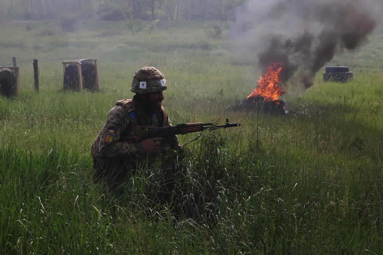 In this handout photograph taken and released by the press service of the 65th Mechanized Brigade of Ukrainian Armed Forces on May 26, 2025, a new recruit takes part in a drill at an undisclosed location on the front line in the Zaporizhzhia region, amid the Russian invasion of Ukraine. (Photo by Andriy Andriyenko / 65th Mechanized Brigade of Ukrainian Armed Forces / AFP) / XGTY / XGTY / RESTRICTED TO EDITORIAL USE - MANDATORY CREDIT  AFP PHOTO /65TH MECHANIZED BRIGADE OF UKRAINIAN ARMED FORCES   - NO MARKETING NO ADVERTISING CAMPAIGNS - DISTRIBUTED AS A SERVICE TO CLIENTS