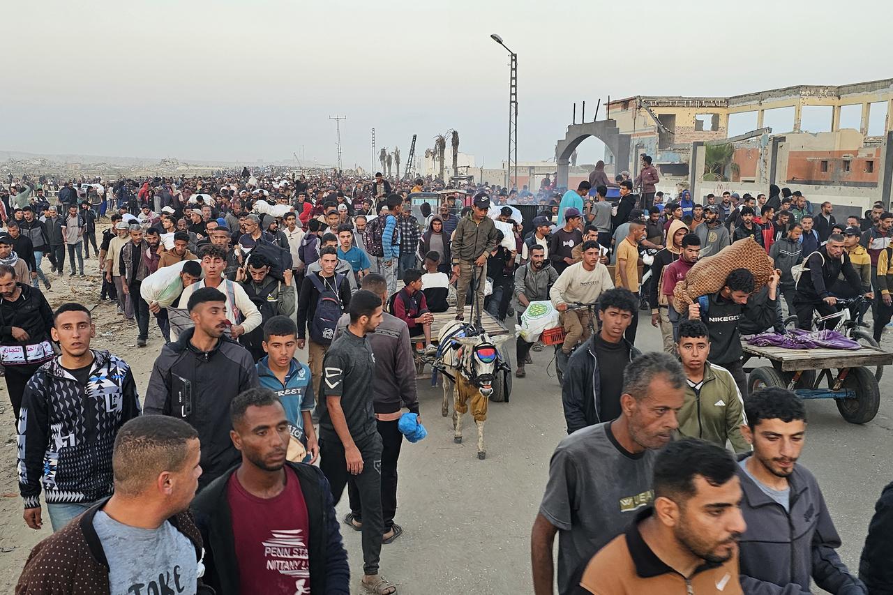 Displaced Palestinians return from a food distribution centre in Rafah in the southern Gaza Strip on June 1, 2025. Gaza rescuers said Israeli gunfire killed at least 10 Palestinians near a US-backed aid distribution site on June 1, shortly after Washington rejected a Hamas ceasefire proposal as  totally unacceptable . (Photo by AFP)