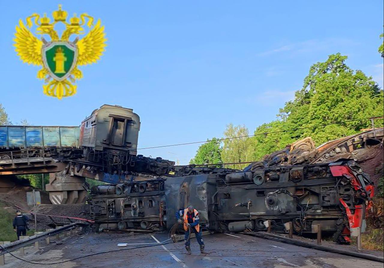 This handout photograph taken and released by the Moscow Interregional Transport Prosecutors Office on June 1, 2025 shows Russian law enforcement officers working at the site of a rail bridge collapse in the Kursk region. Seven people were killed and dozens injured after bridges in two separate Russian regions bordering Ukraine collapsed overnight, officials said Sunday, with rail authorities blaming at least one incident on  illegal interference . (Photo by Handout / Moscow Interregional Transport Prosecutors Office / AFP) / RESTRICTED TO EDITORIAL USE - MANDATORY CREDIT  AFP PHOTO / MOSCOW INTERREGIONAL TRANSPORT PROSECUTORS OFFICE  - NO MARKETING NO ADVERTISING CAMPAIGNS - DISTRIBUTED AS A SERVICE TO CLIENTS