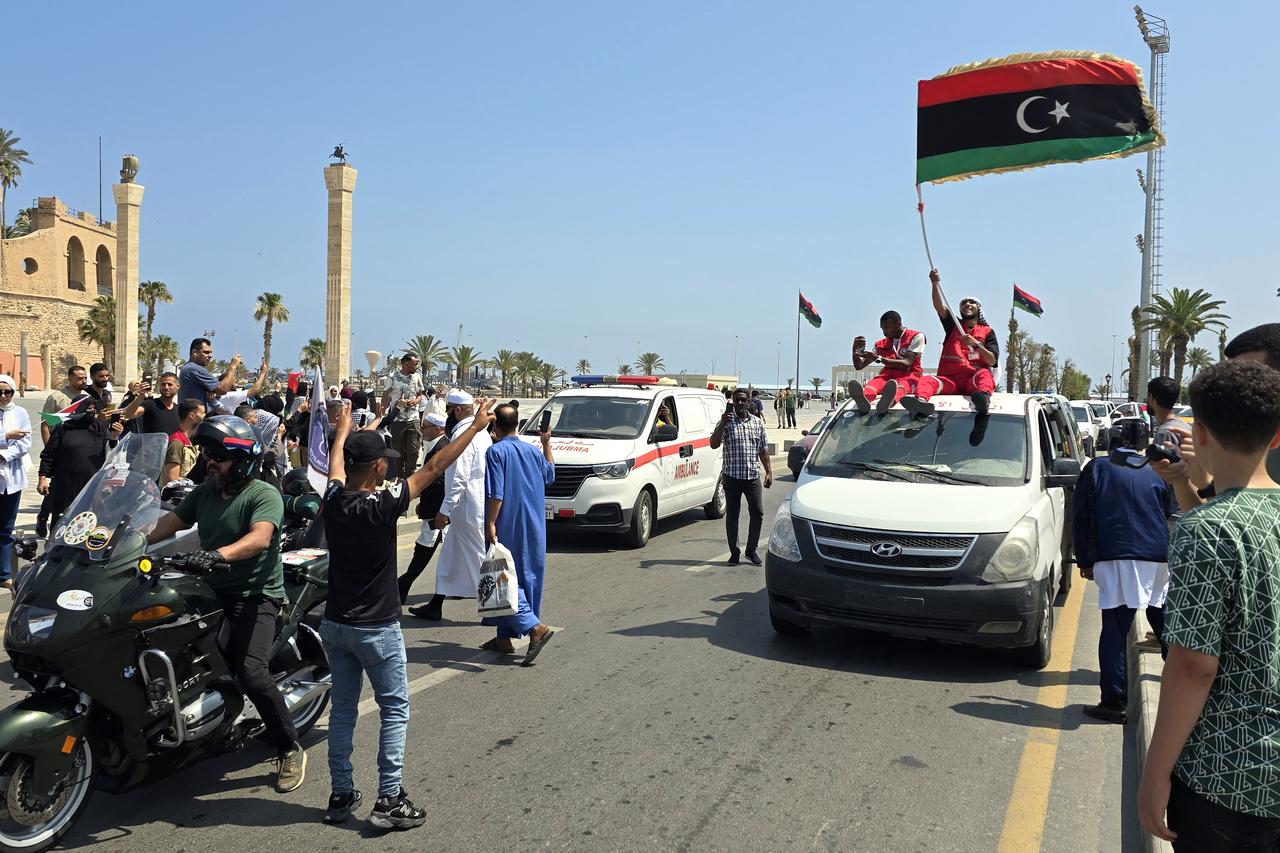 Activists, heading towards Gaza by land with the aim of breaking the siege on the Palestinian territory, are greeted by Libyans in Tripolis Martyrs Square on June 11, 2025. (AFP Photo)