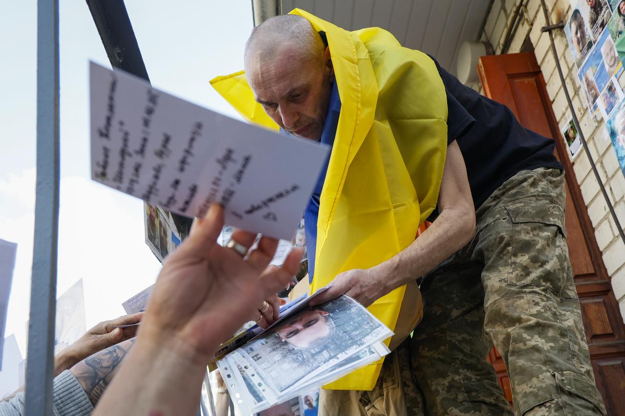 Ukrainian POWs are reunited with their loved ones carrying their photos after they are freed as part of the second phase of the prisoner exchange held in Chernihiv Region, Ukraine on June 10, 2025. (AA Photo)
