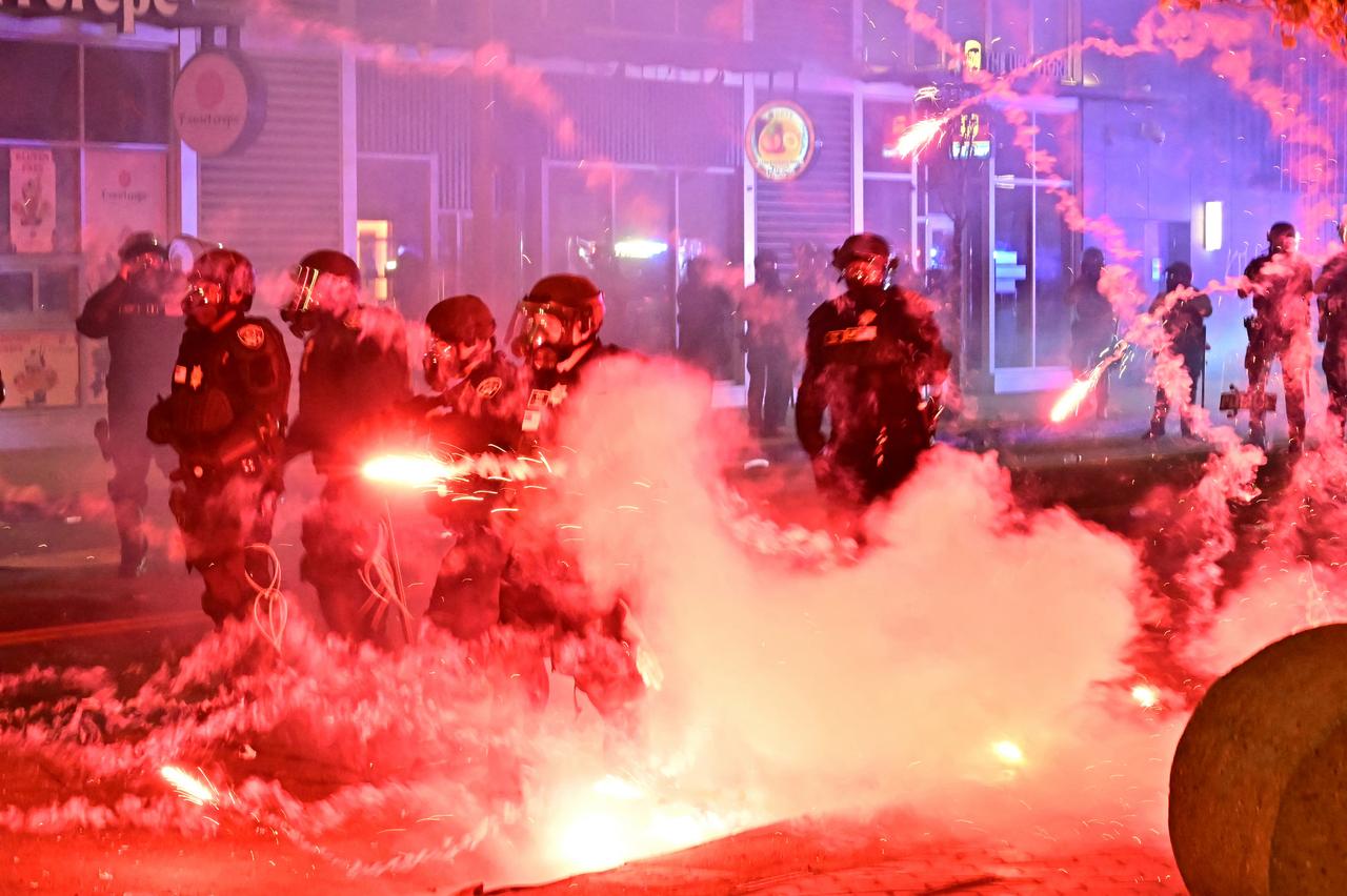 Fireworks explode around police officers in riot gear during a protest in response to federal immigration operations in the Little Tokyo neighborhood of downtown Los Angeles, on June 9, 2025. (AFP Photo)