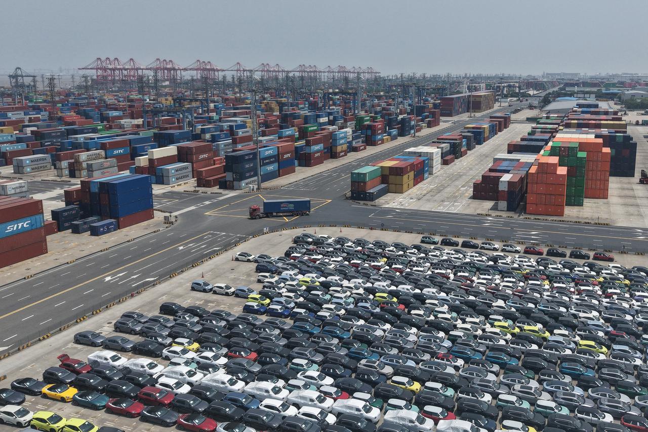 Chinese made cars and containers are seen before being loaded onto ships at the port in Shanghai on June 11, 2025. (AFP Photo)