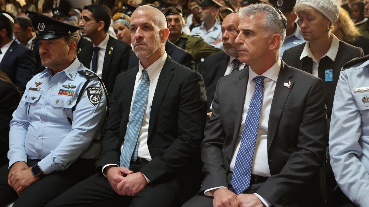 Mossad intelligence agency chief David Barnea (R) and Ronen Bar (2nd L), then-chief of Israel's domestic Shin Bet security agency, attend a ceremony at Jerusalem's Mount Herzl military cemetery on May 13, 2024. (AFP Photo)
