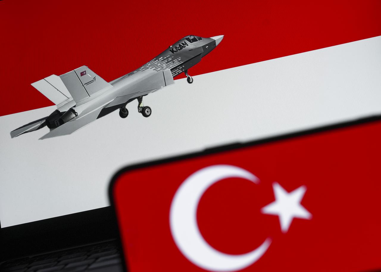 In this photo illustration, Turkish flag is displayed on a mobile phone screen in front of the Indonesian flag and Turkish national fighter jet KAAN display in Ankara, Türkiye on July 10, 2025. (AA Photo)