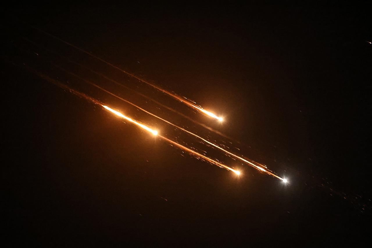 Debris of missiles fired from Iran toward Israel leave trails in the night sky over Nablus in the occupied West bank after being intercepted on June 13, 2025. (AFP Photo)