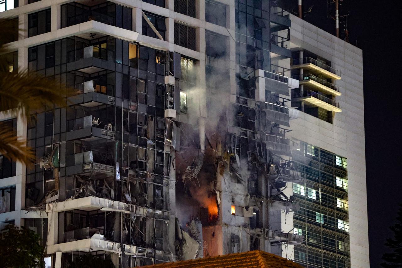 Fire and smoke rise from a building, reportedly hit by a missile fired from Iran, in central Tel Aviv on June 13, 2025. (AFP Photo)