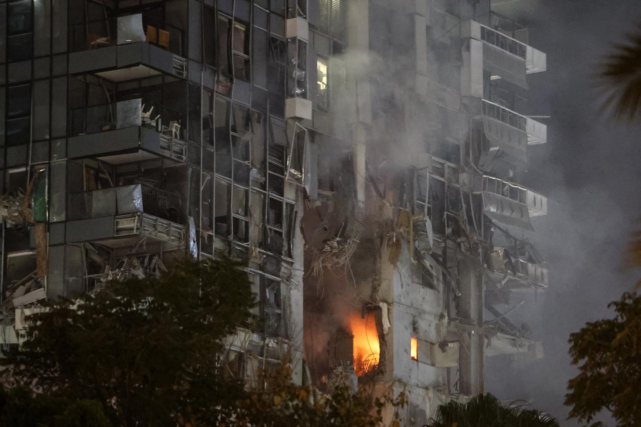 Fire and smoke rise from a building, reportedly hit by a missile fired from Iran, in central Tel Aviv, Israel on June 13, 2025. (AFP Photo)