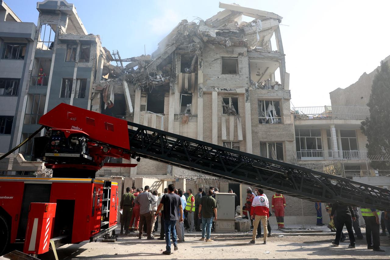 Rescue teams work outside a heavily damaged building, targeted by an Israeli strike in the Iranian capital Tehran on June 13, 2025. (AFP Photo)
