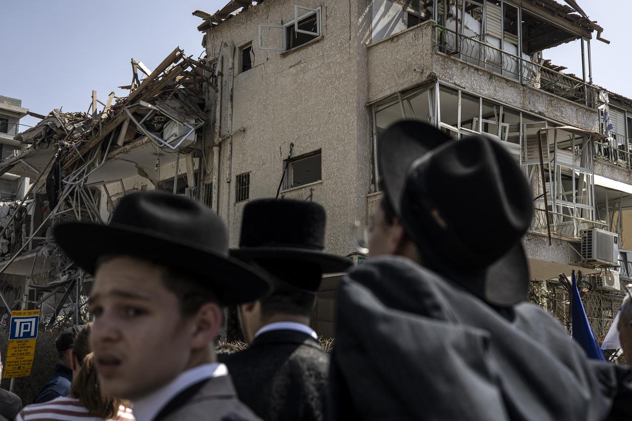 Ultra-Orthodox Jewish men look on at a site in Tel Aviv hit by a missile fired from Iran on June 14, 2025. (AFP Photo)
