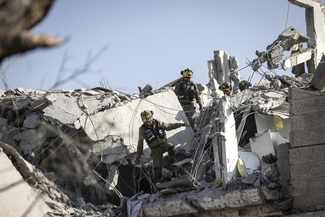 Israeli emergency responders inspect a site hit by a missile fired from Iran south of Tel Aviv on June 14, 2025. (AFP Photo)