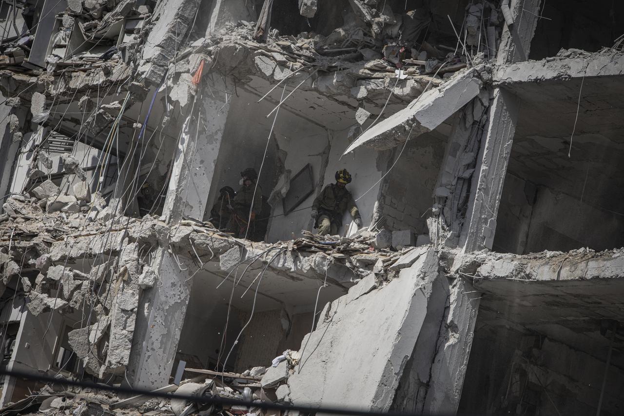 Israeli emergency responders search for victims amid the rubble of a damaged building following an overnight Iranian missile strike in Bat Yam on June 15, 2025. (AFP Photo)