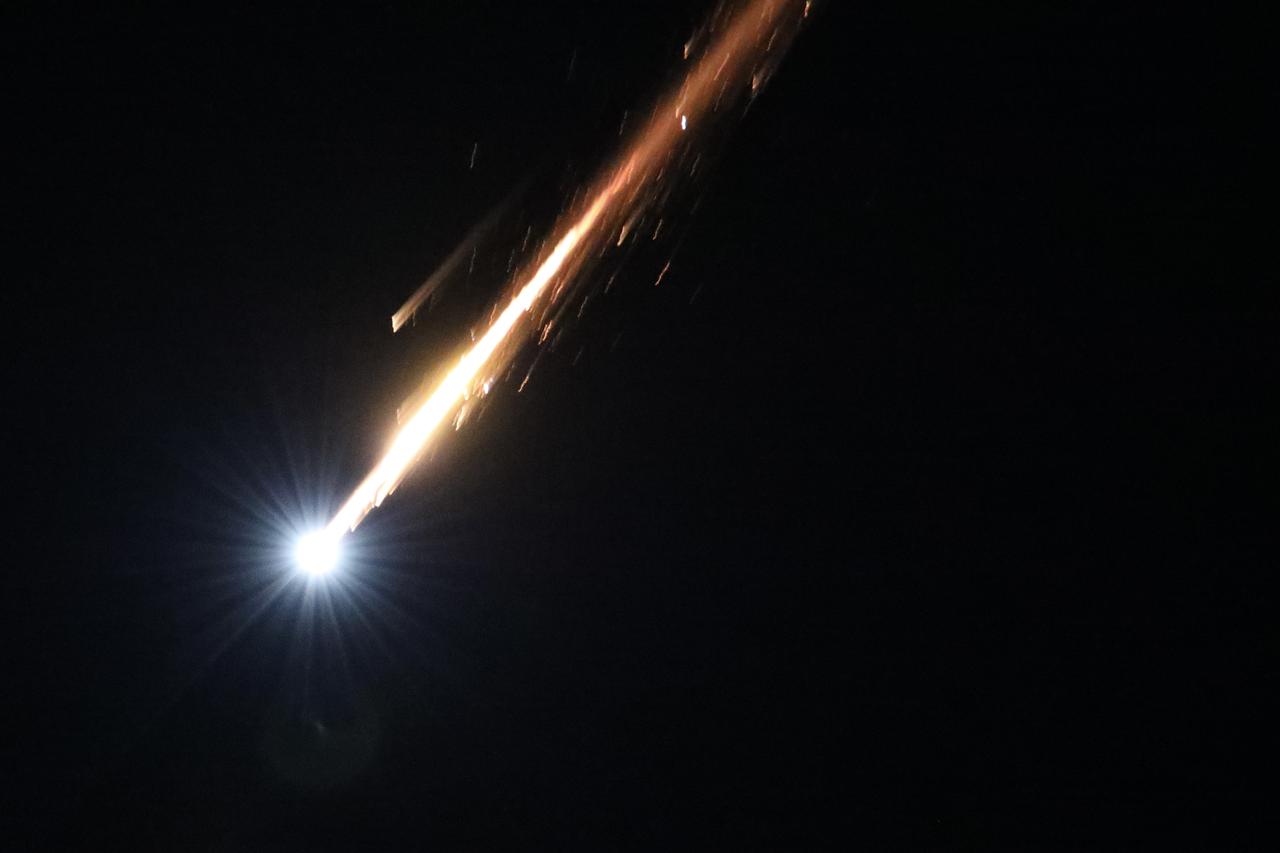 A streak of light cuts through the night sky above Jerusalem as Israel’s Iron Dome air defense system responds to incoming Iranian ballistic missiles on June 15, 2025. (AA Photo)
