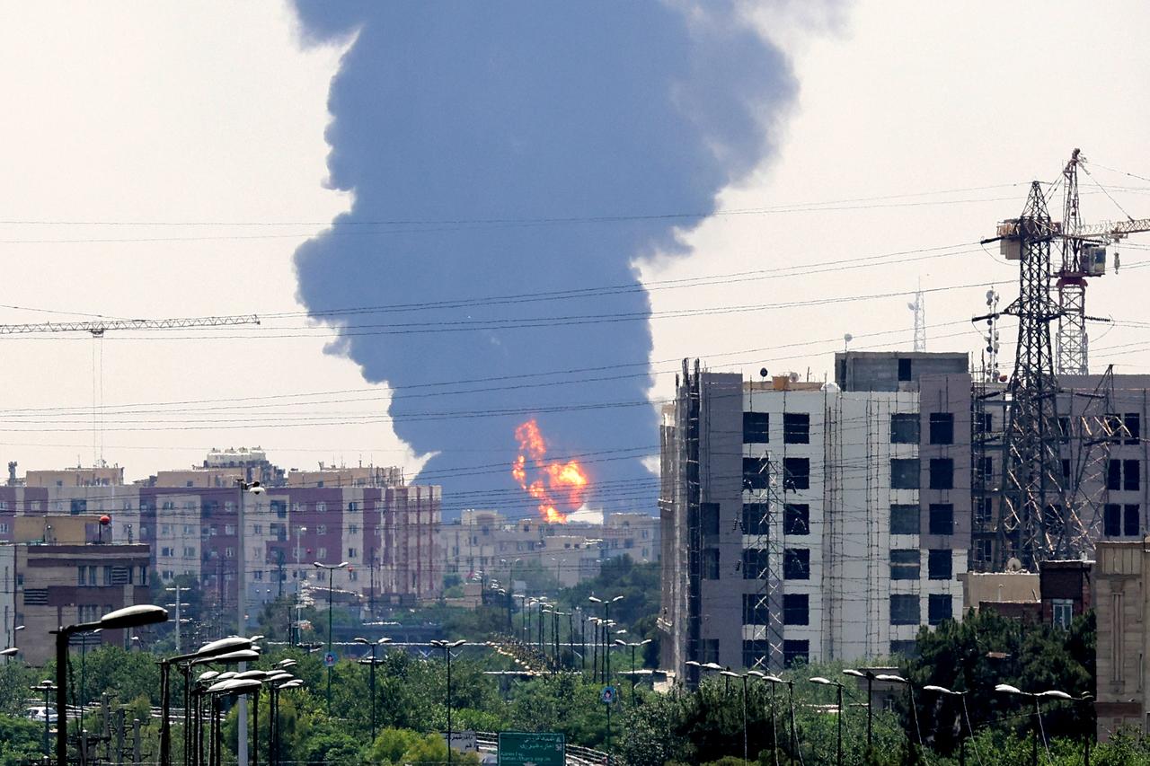 A plume of heavy smoke and fire rise from an oil refinery in southern Tehran, after it was hit in an overnight Israeli strike, on June 15, 2025. (AFP Photo)