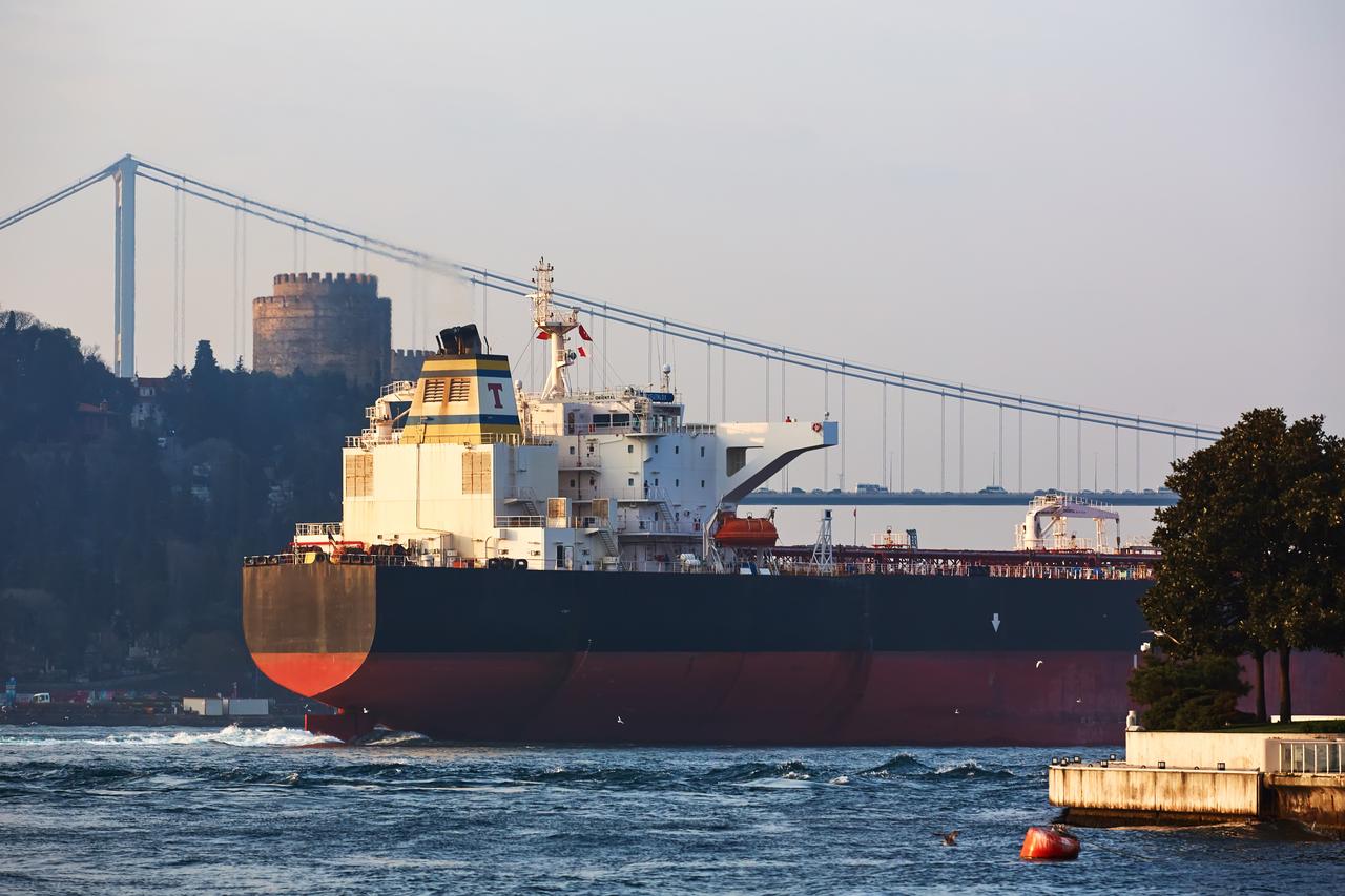A crude oil tanker sails through the Bosporus Strait with Rumeli Fortress and the Fatih Sultan Mehmet Bridge in the background, in Istanbul, Türkiye, accessed on June 15, 2025. (Adobe Stock Photo)