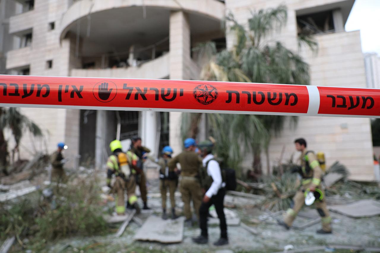 Responders inspect a damaged building following a strike by an Iranian missile in the Israeli city of Petah Tikva, east of Tel Aviv, on June 16, 2025. (AFP Photo)