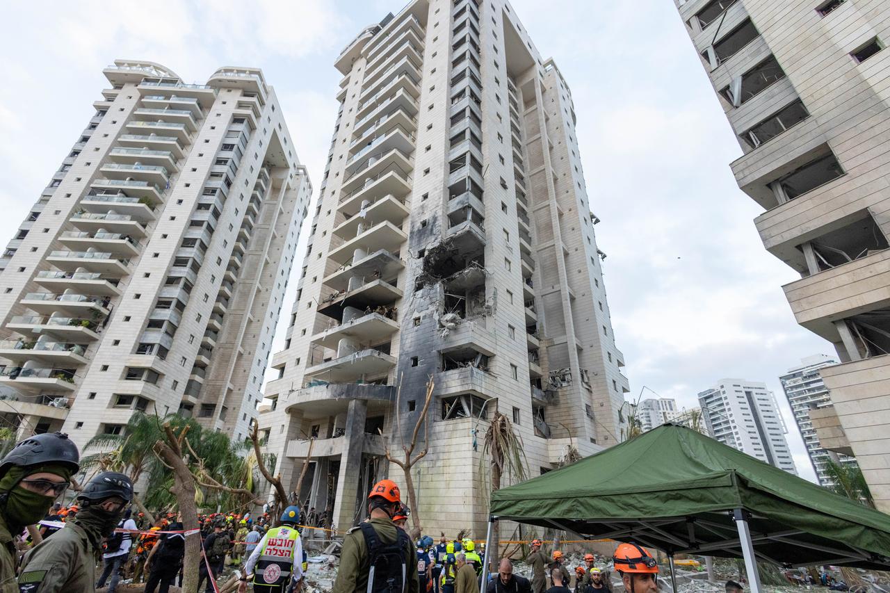 Israeli emergency teams conduct search and rescue operations at a damaged building after ballistic missiles fired from Iran struck parts of Petah Tikva, Israel, on June 16, 2025. (AA Photo)