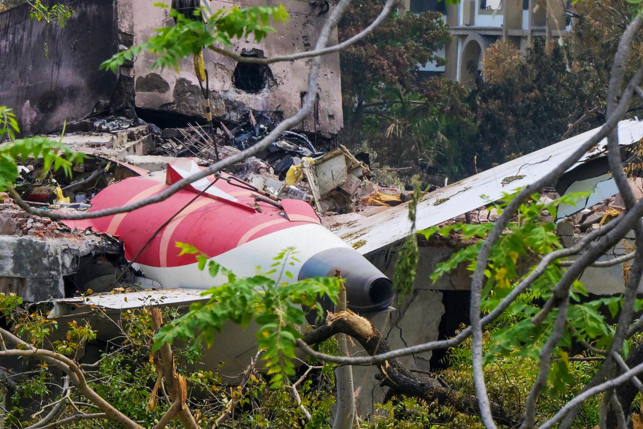 A crane removing aeroplane's tail from the wreckage after the June 12 Air India flight 171 crash, is pictured in a residential area near the airport in Ahmedabad, June 14, 2025. (AFP Photo)