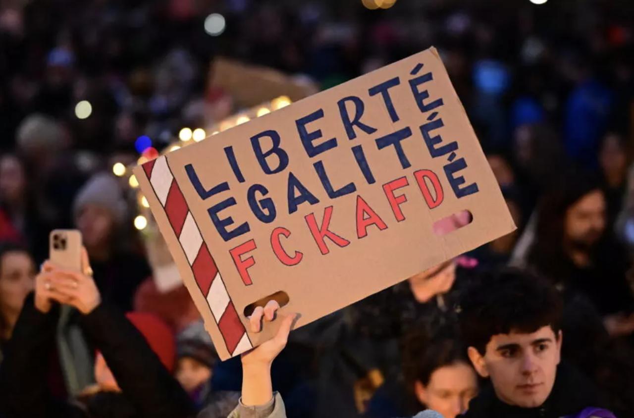 A protestor holds up a sign that reads "Liberte, Egalite, FckAfDe" during a rally against the far-right in Berlin, Germany, Jan. 25, 2025. (AFP Photo)
