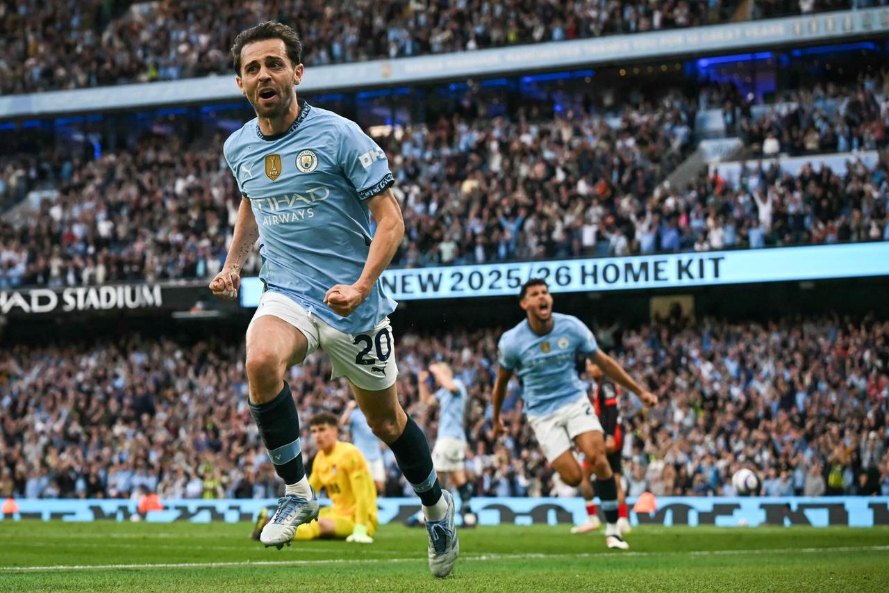 Manchester Citys Portuguese midfielder #20 Bernardo Silva celebrates after scoring his team second goal during the English Premier League football match between Manchester City and Bournemouth at the Etihad Stadium in Manchester, north west England, on May 20, 2025.  (AFP Photo)