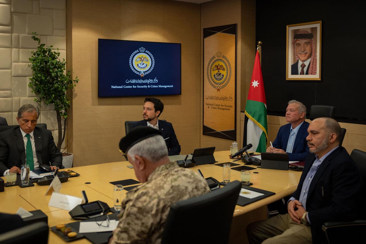 This handout picture released by the Jordanian Royal Palace on June 16, 2025 shows Jordans King Abdullah II heading a meeting at the National Center for Security and Crisis Management in Amman to discuss the kingdoms readiness to deal with the consequences of the Israeli-Iranian war in the presence of Crown Prince Hussein (2nd L) and the kings brother, Prince Faisal (R). (Photo by Jordanian Royal Palace / AFP)