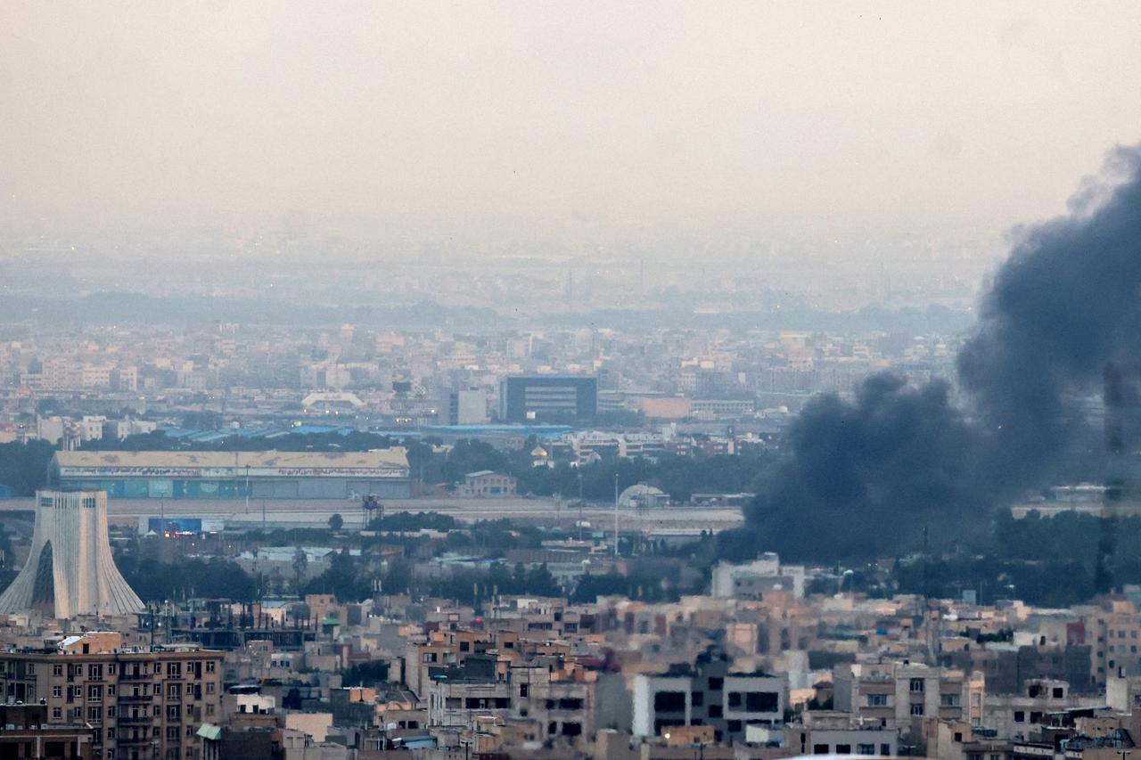 Smoke billows from a site near the Azadi Tower (L) in central Tehran, as fighting between Israel and Iran continues on June 16, 2025. (AFP Photo)