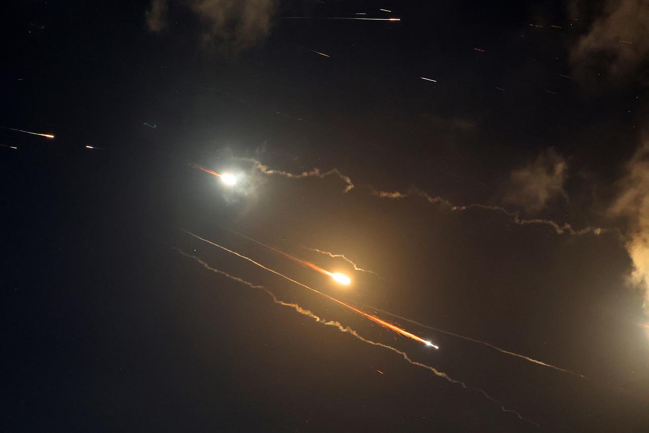 Rocket trails are seen in the sky above the Israeli coastal city of Netanya amid a fresh barrage of Iranian missile attacks on June 16, 2025. (AFP Photo)