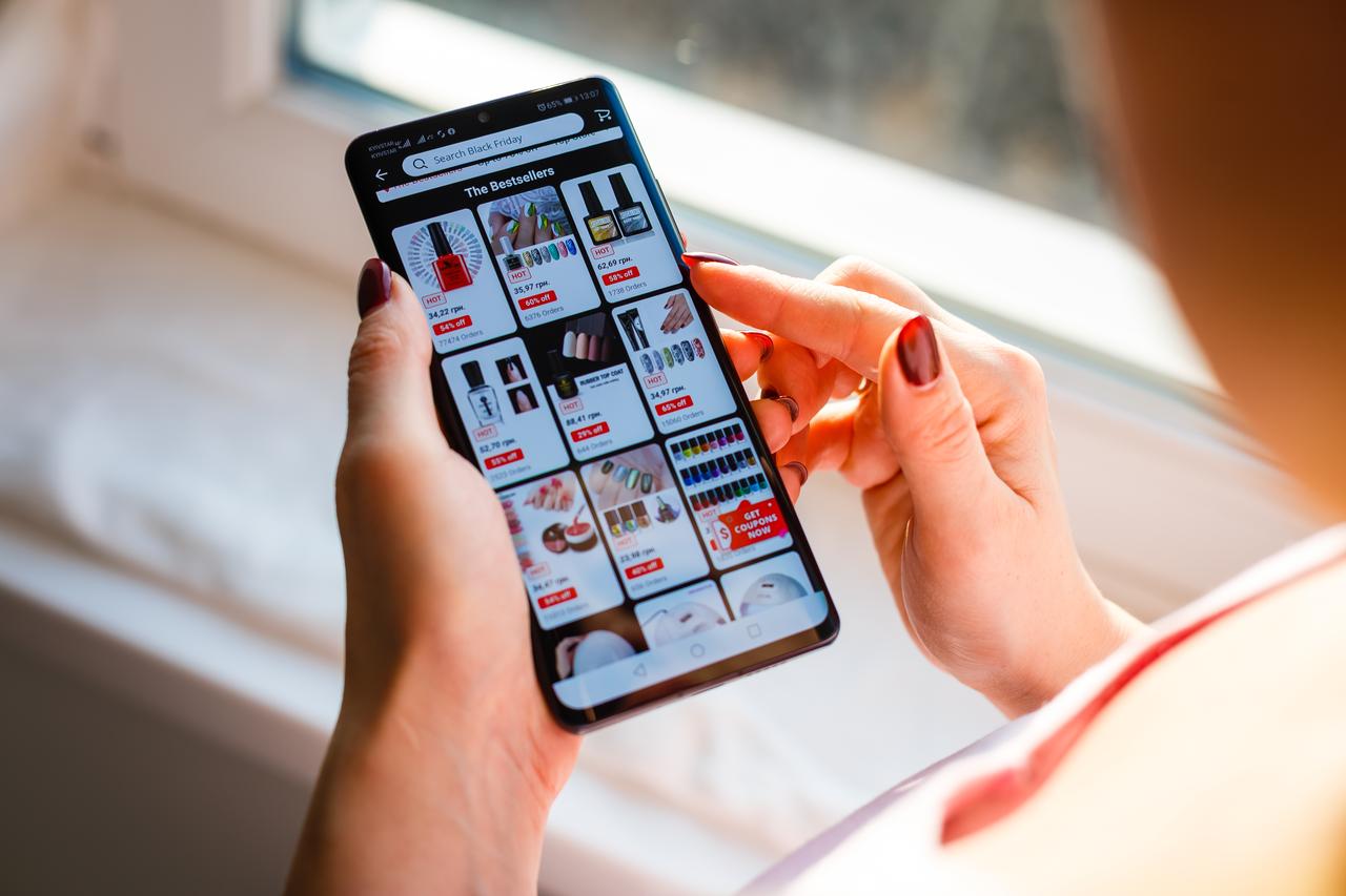 A user browses discounted cosmetic products on the AliExpress mobile app during a Black Friday sale in Kyiv, Ukraine, on November 26, 2019. (Adobe Stock Photo)