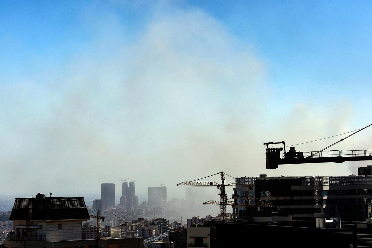 Smoke rises above buildings in Tehran following an Israeli strike on June 18, 2025. (AFP Photo)