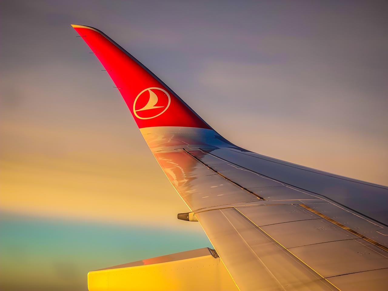 A Turkish Airlines aircraft wing is seen against a sunset sky during a flight over Istanbul, Türkiye, January 14, 2025. (Adobe Stock Photo)