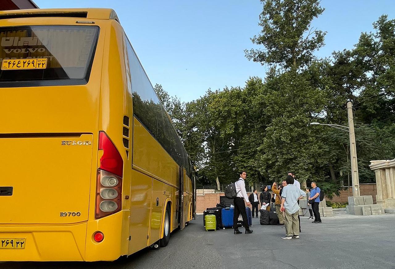 This handout photo taken on June 17, 2025 and provided by the South Korean Foreign Ministry on June 19, 2025 shows South Koreans and their Iranian family members boarding a bus in Tehran during their evacuation from Iran to Turkmenistan. (Photo by Handout / South Korean Foreign Ministry / AFP)