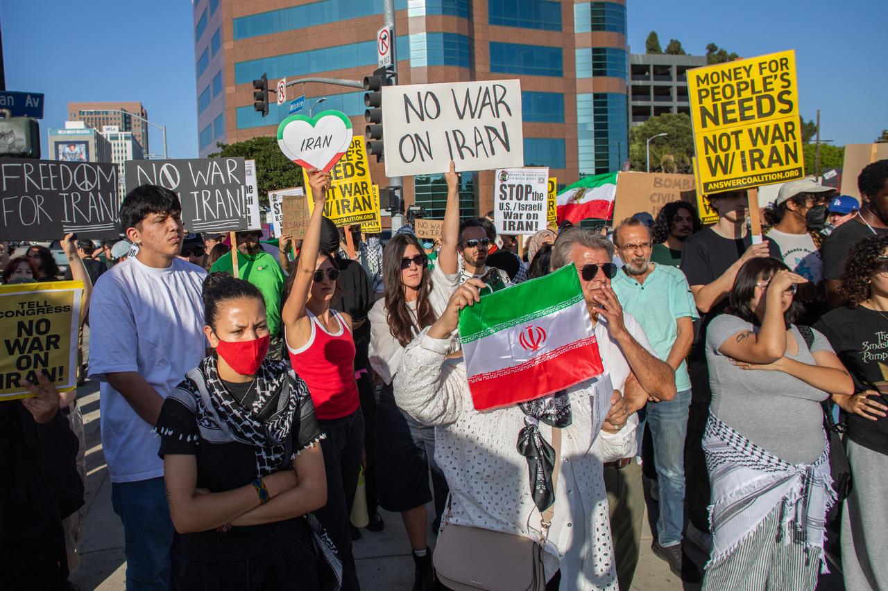 Protesters hold Iranian flags and signs as they rally during a "No War on Iran" demonstration outside the Wilshire Federal Building in Los Angeles on June 18, 2025. (AFP Photo)