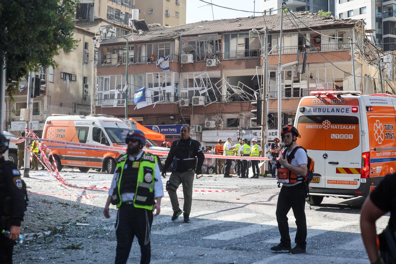 Israeli emergency services stand in front of a damaged building at the site of an Iranian missile attack in Ramat Gan in central Israel on June 19, 2025. (AFP Photo)