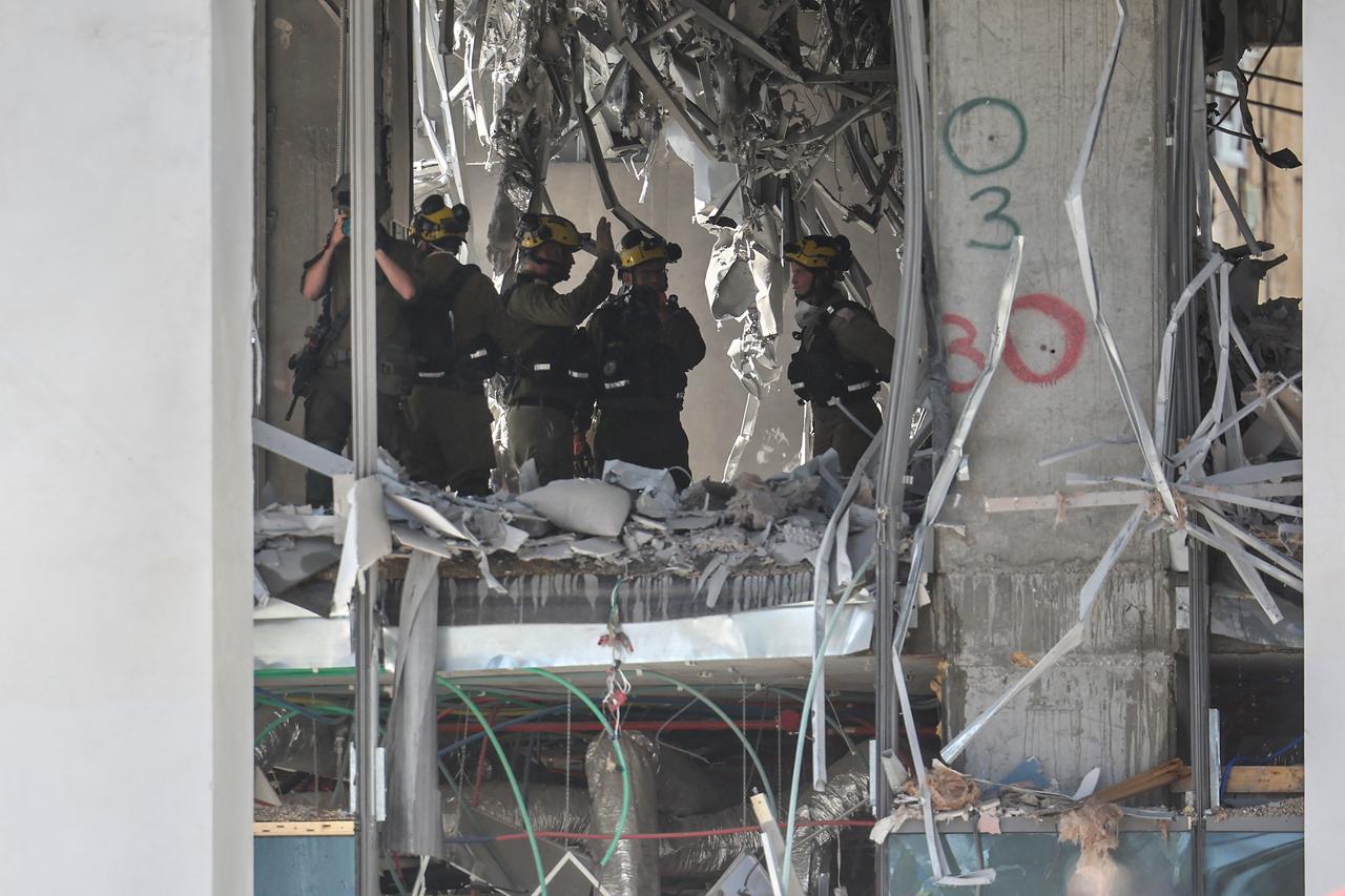 Israeli emergency services inspect a heavily damaged building at the site of an Iranian missile attack in Ramat Gan in central Israel on June 19, 2025. (AFP Photo)