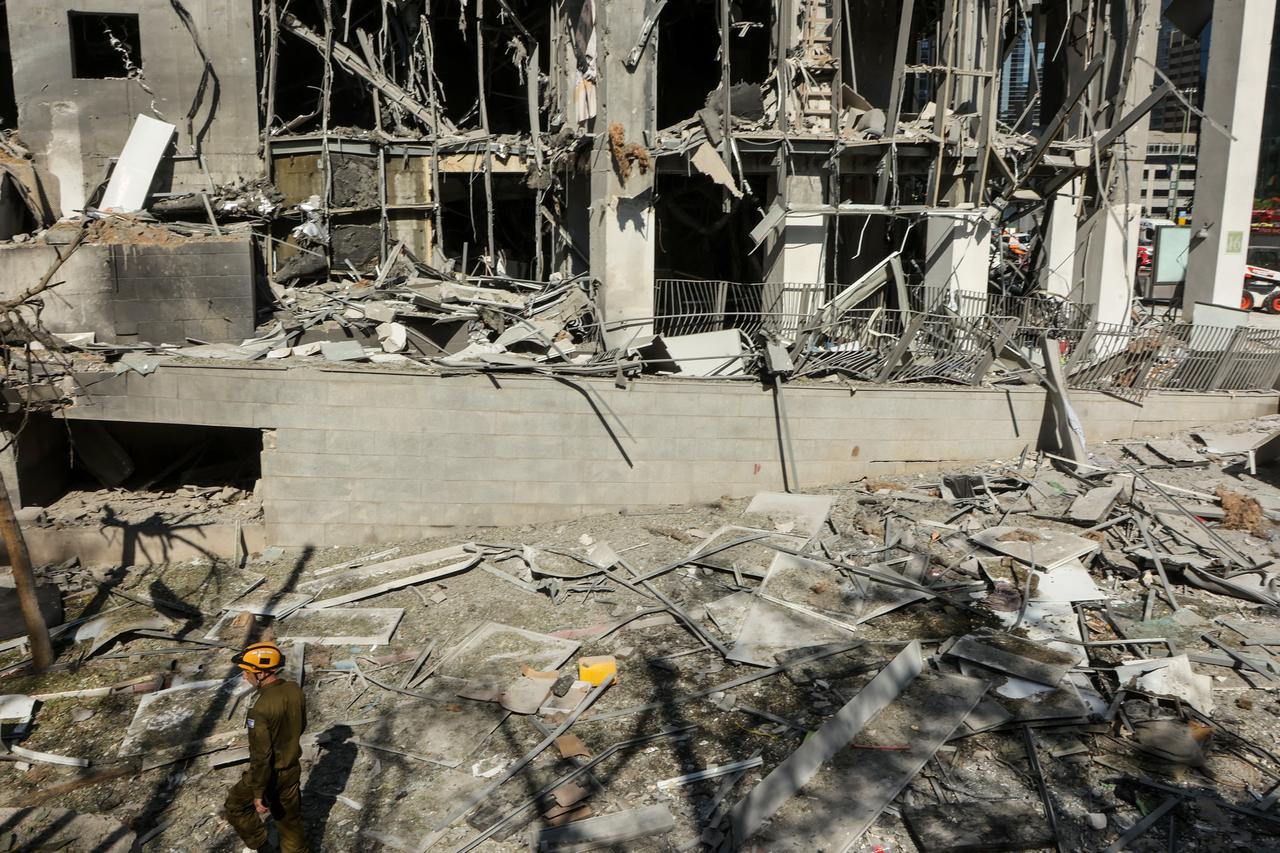 A member of the Israeli emergency service walks at the site of an Iranian missile attack in Ramat Gan in central Israel near Tel Aviv, on June 19, 2025. (AFP Photo)