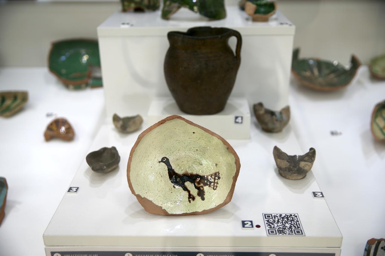 Glazed ceramics featuring various figures, unearthed during excavations at the Ani archaeological site—listed as a UNESCO World Heritage Site in Kars, Türkiye—are on display, June 18, 2025. (AA Photo)